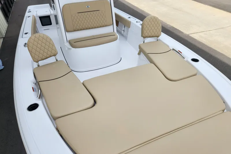 Slide: The Image of 2026 Sportsman Masters 227 Bay Boat with beige cushioned seating and sleek design. - 10