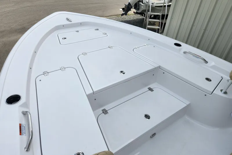 Slide: The Image of 2026 Sportsman Masters 227 Bay Boat deck with storage compartments and sleek design. - 11