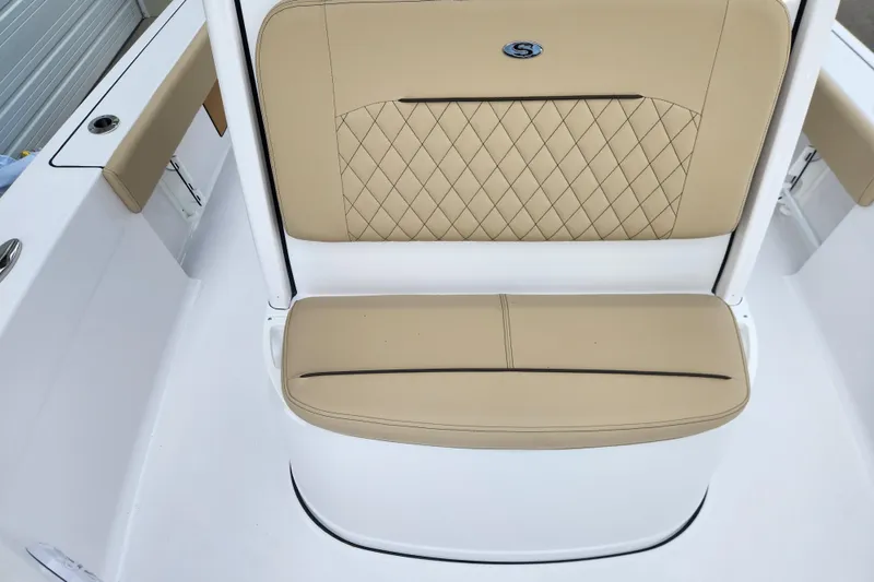 Slide: The Image of 2026 Sportsman Masters 227 Bay Boat seat with tan upholstery and diamond stitching. - 16