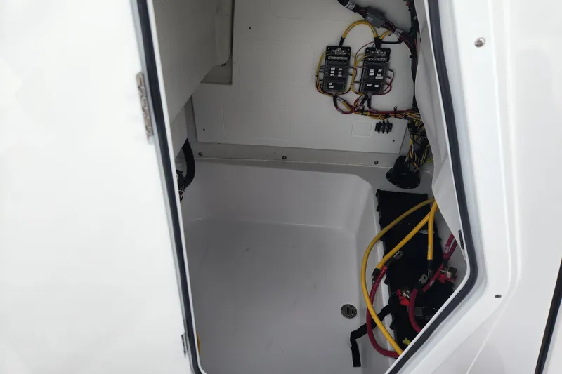 Slide: The Image of 2026 Sportsman Masters 227 Bay Boat electrical compartment with wiring and components. - 18
