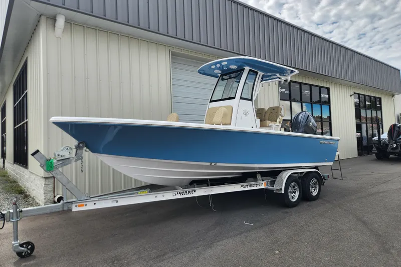 Slide: The Image of 2026 Sportsman Masters 227 Bay Boat on trailer outside a building. - 2