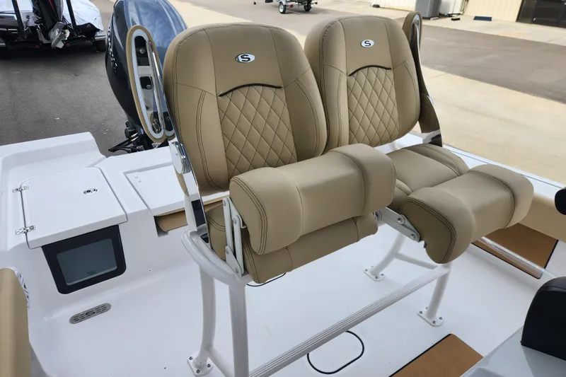 Slide: The Image of 2026 Sportsman Masters 227 Bay Boat with tan leather seats and modern design. - 22