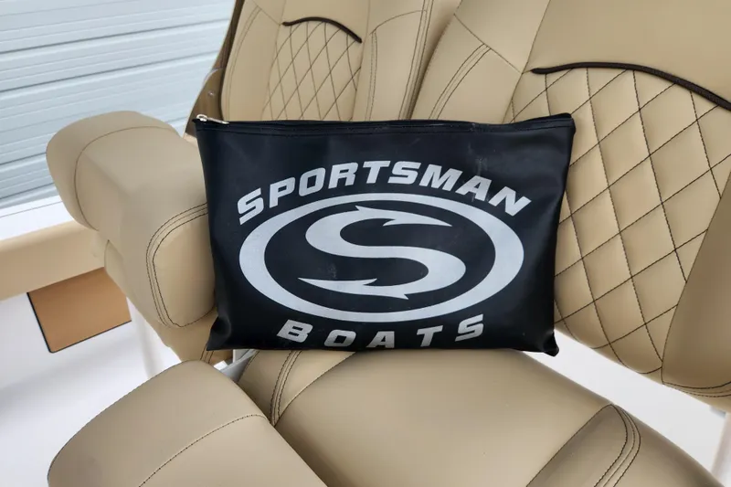 Slide: The Image of Beige leather seats on 2026 Sportsman Masters 227 Bay Boat with branded pouch. - 26