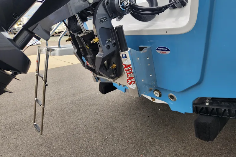 Slide: The Image of 2026 Sportsman Masters 227 Bay Boat rear view with motor and ladder. - 6