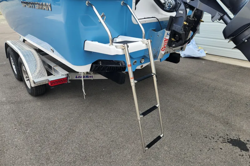 Slide: The Image of 2026 Sportsman Masters 227 Bay Boat with ladder and trailer, rear view. - 7