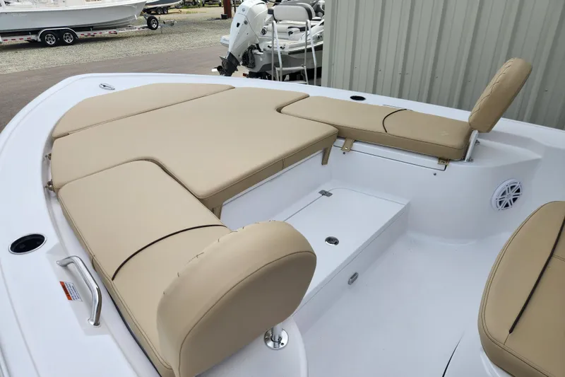 Slide: The Image of 2026 Sportsman Masters 227 Bay Boat with beige cushioned seating and spacious deck layout. - 9