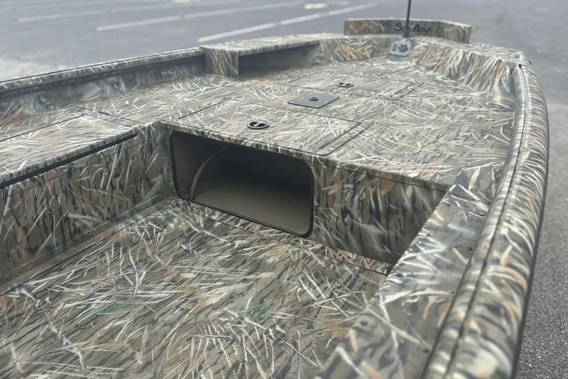 Slide: The Image of 2026 SeaArk 1752 Slayer X boat interior with camouflage design and battery setup. - 12