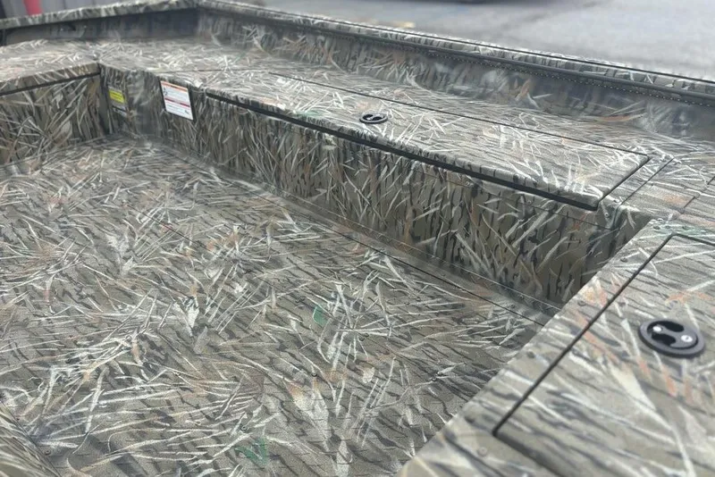 Slide: The Image of 2026 SeaArk 1752 Slayer X boat on trailer, parked outdoors with Mercury outboard motor. - 13