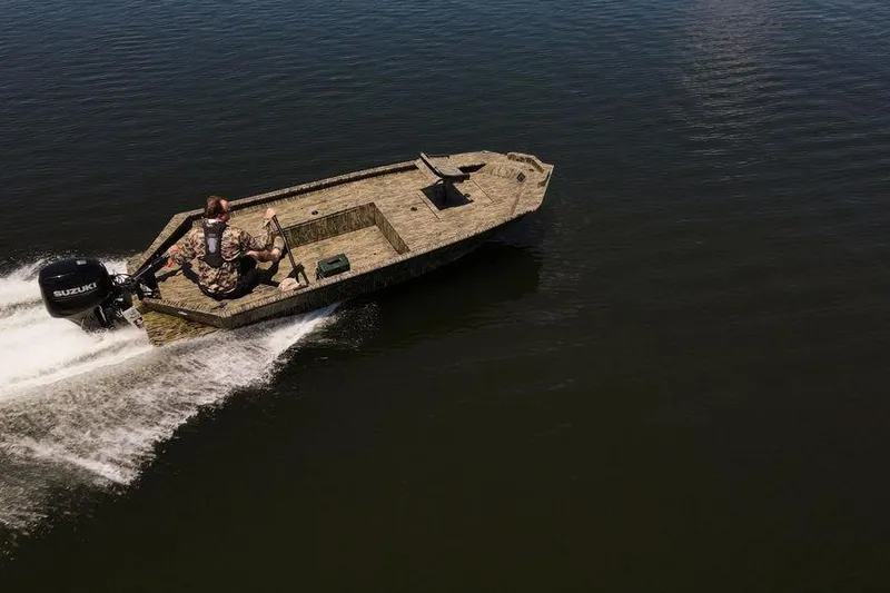 Slide: The Image of 2026 SeaArk 1752 Slayer X boat cruising on open water, featuring a Suzuki outboard motor. - 25