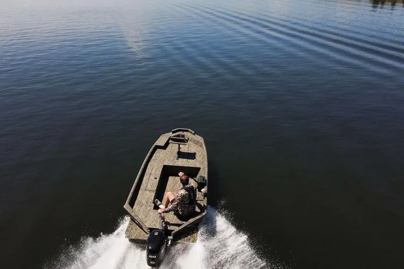 Slide: The Image of Aerial view of 2026 SeaArk 1752 Slayer X boat cruising on calm water. - 27