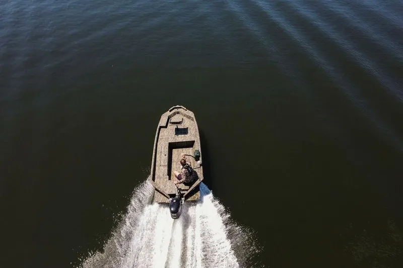 Slide: The Image of Aerial view of 2026 SeaArk 1752 Slayer X boat speeding on water. - 29