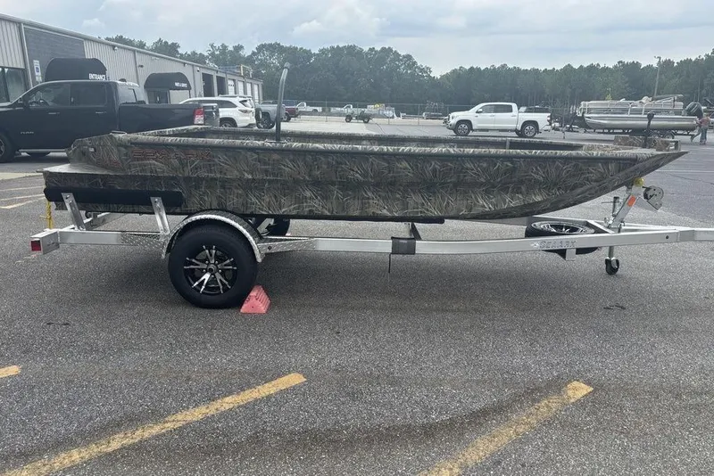 Slide: The Image of 2026 SeaArk 1752 Slayer X boat with Mercury engine on trailer in parking lot. - 7