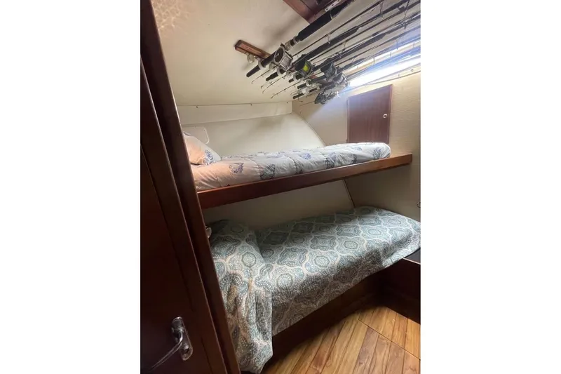 Slide: The Image of 1979 Hatteras 53 Motor Yacht with Novurania tender on deck, moored in a marina. - 11