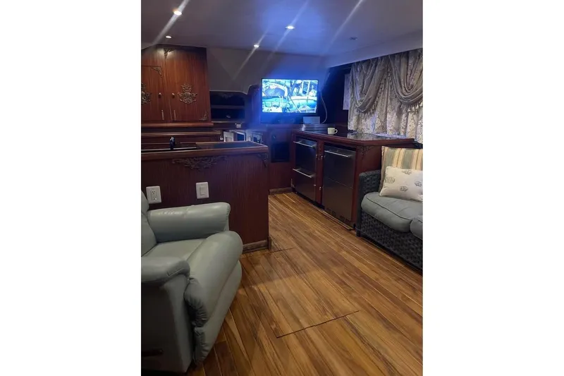 Slide: The Image of 1979 Hatteras 53 Motor Yacht docked, featuring sleek white exterior and railing. - 13