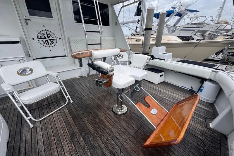 Slide: The Image of 1979 Hatteras 53 Motor Yacht deck with fishing chair and nautical decor. - 21