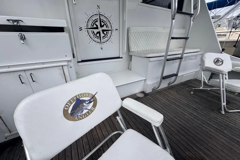 Slide: The Image of 1979 Hatteras 53 Motor Yacht deck with compass design and Offshore Angler chairs. - 27