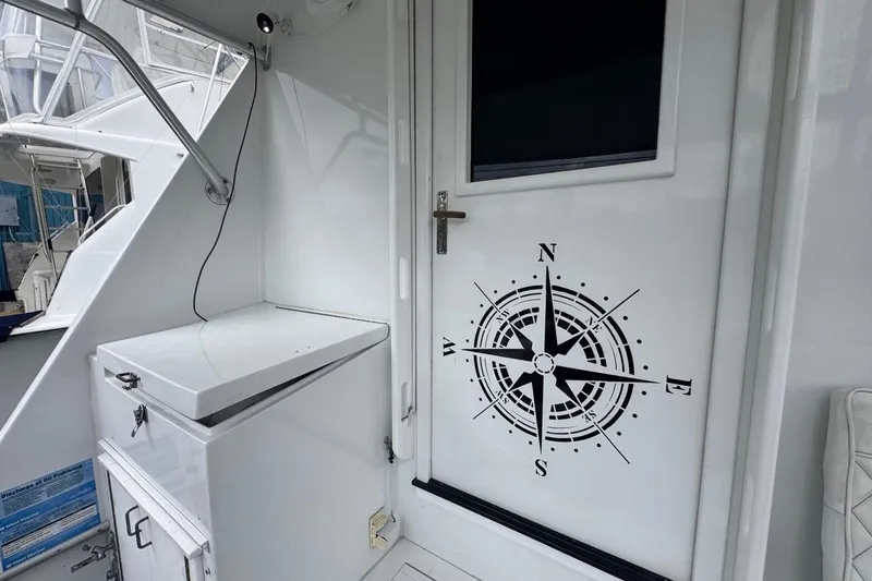 Slide: The Image of 1979 Hatteras 53 Motor Yacht interior with compass design on door. - 28