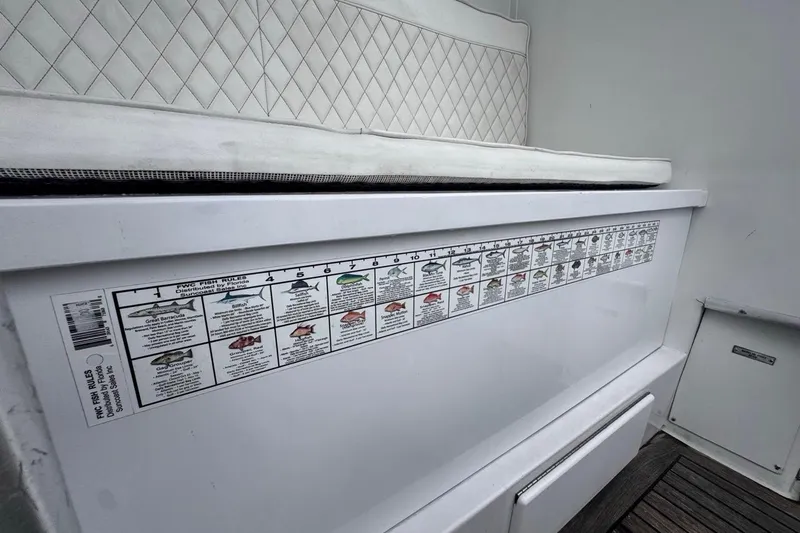 Slide: The Image of 1979 Hatteras 53 Motor Yacht with fish identification chart and cushioned seating. - 31