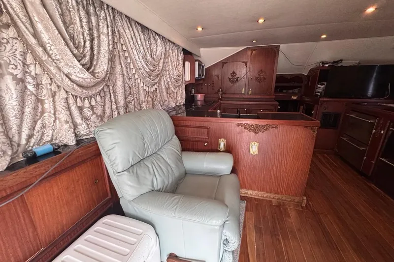 Slide: The Image of Interior of 1979 Hatteras 53 Motor Yacht with elegant woodwork and plush seating. - 33