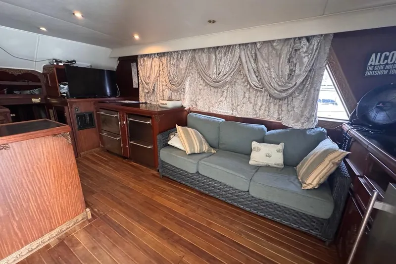 Slide: The Image of Interior of 1979 Hatteras 53 Motor Yacht with sofa, TV, and wooden flooring. - 34