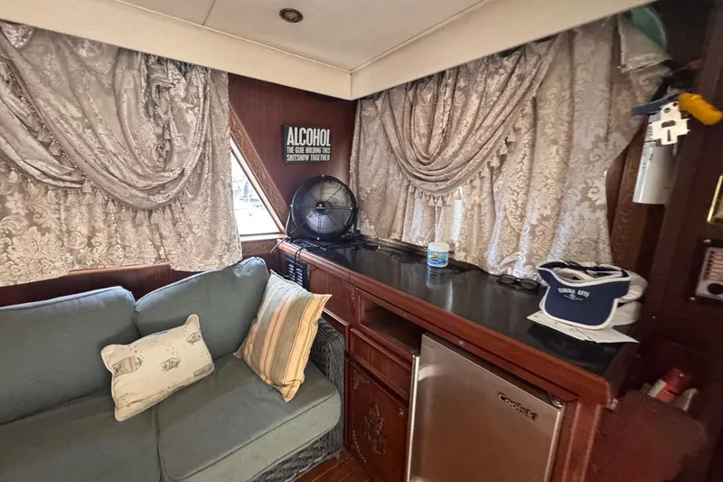 Slide: The Image of Interior of 1979 Hatteras 53 Motor Yacht with sofa, decorative curtains, and mini fridge. - 35