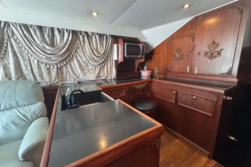 Slide: The Image of Luxurious interior of a 1979 Hatteras 53 Motor Yacht with elegant wood cabinetry. - 37