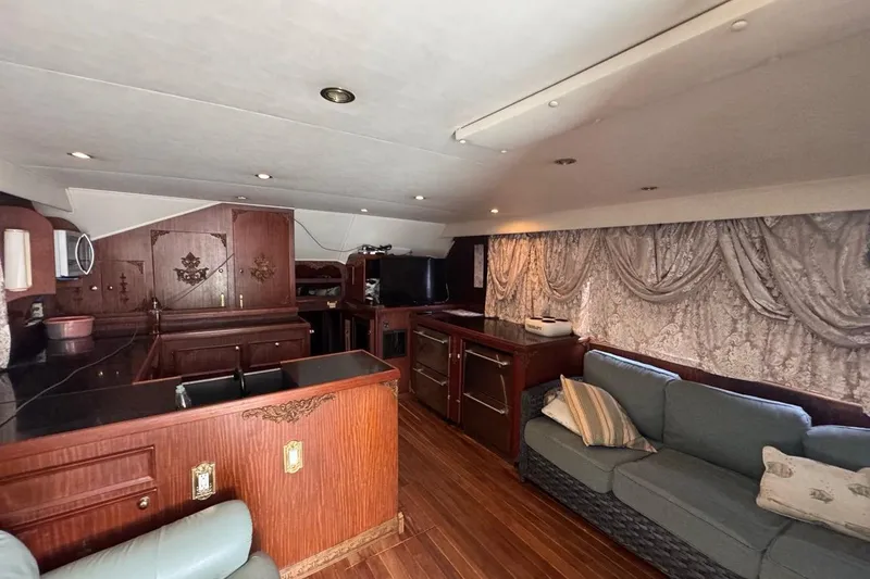 Slide: The Image of Interior of a 1979 Hatteras 53 Motor Yacht with elegant wood finishes and cozy seating. - 40