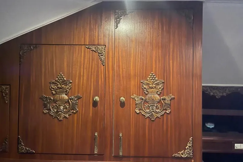 Slide: The Image of Ornate wooden cabinet doors on a 1979 Hatteras Sportfish 53' yacht interior. - 41