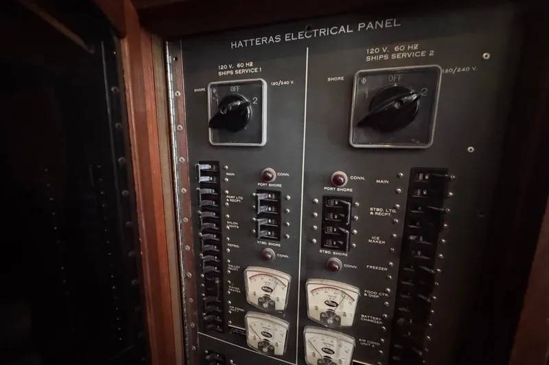 Slide: The Image of Electrical panel of a 1979 Hatteras 53 Motor Yacht, featuring switches and meters. - 43
