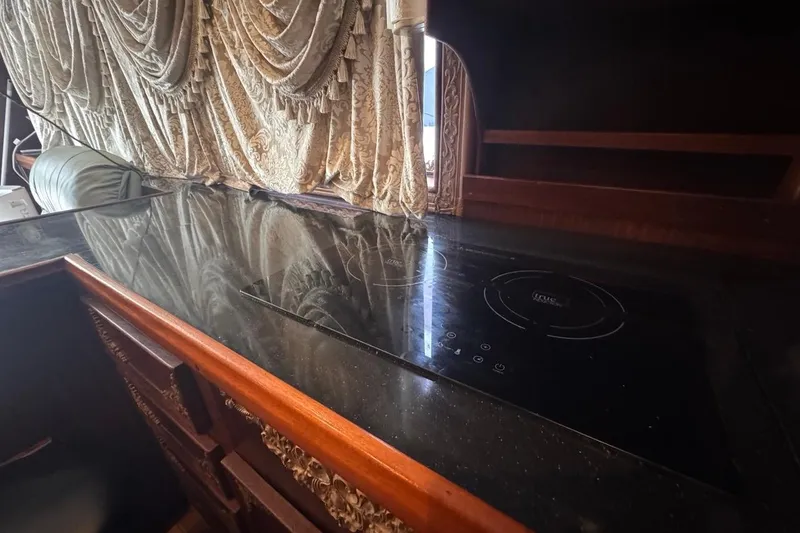 Slide: The Image of Luxurious kitchen interior of 1979 Hatteras 53 Motor Yacht with elegant drapery and modern cooktop. - 45