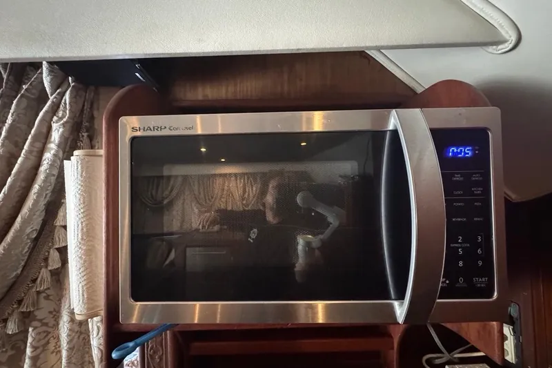 Slide: The Image of Sharp Carousel microwave inside a 1979 Hatteras 53 Motor Yacht, with elegant curtains. - 46