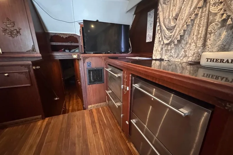 Slide: The Image of Interior of 1979 Hatteras 53 Motor Yacht with wood paneling and modern appliances. - 47