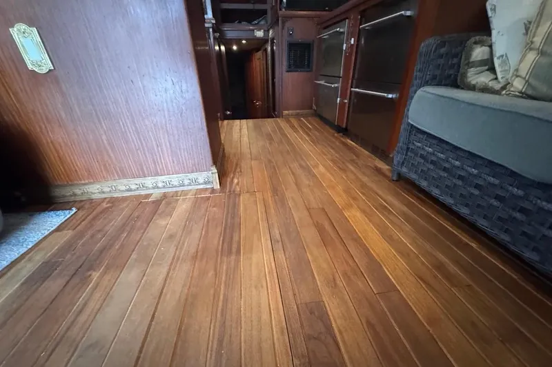 Slide: The Image of Interior of 1979 Hatteras 53 Motor Yacht with wooden flooring and seating area. - 49