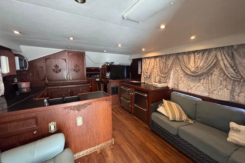 Slide: The Image of Interior of 1979 Hatteras 53 Motor Yacht with wood paneling and elegant furnishings. - 52