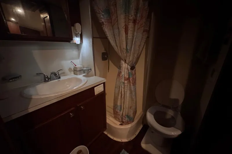 Slide: The Image of 1979 Hatteras 53 Motor Yacht bathroom with sink, shower, and toilet. - 54