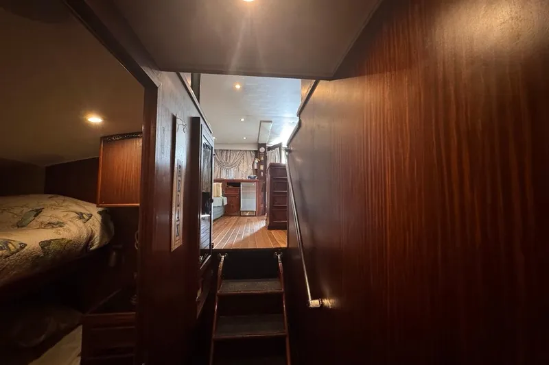 Slide: The Image of Interior of 1979 Hatteras 53 Motor Yacht with wooden paneling and cozy cabin. - 60