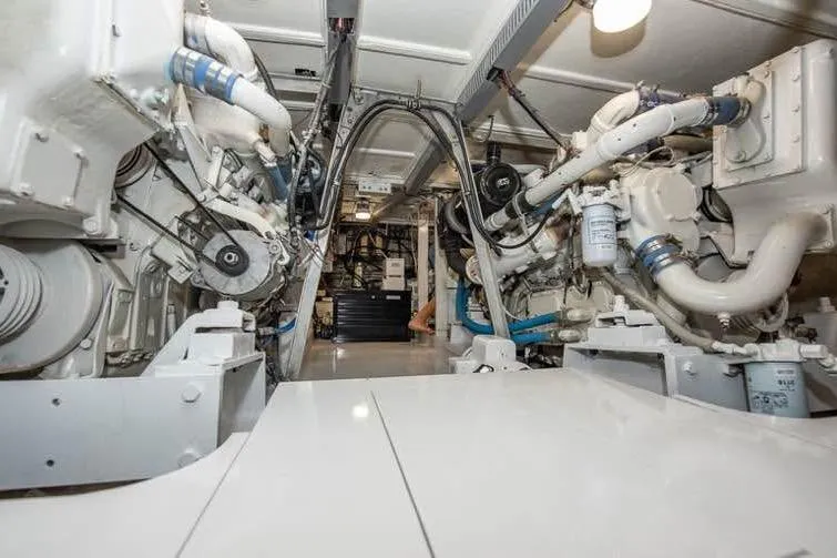 Slide: The Image of Engine room of a 1979 Hatteras Sportfish 53', showcasing mechanical components and systems. - 62