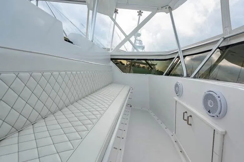 Slide: The Image of Interior of 1979 Hatteras Sportfish 53' yacht with white quilted seating and windows. - 64