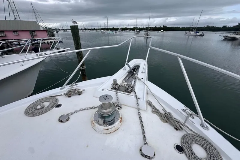 Slide: The Image of Bow view of 1979 Hatteras 53 Motor Yacht docked in a marina. - 65