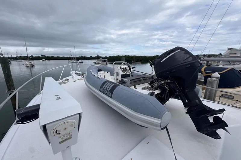 Slide: The Image of 1979 Hatteras 53 Motor Yacht with inflatable boat on deck, docked in a marina. - 67