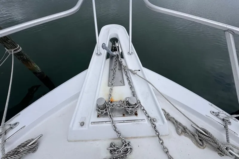 Slide: The Image of Bow of 1979 Hatteras 53 Motor Yacht with anchor chain and calm water. - 69