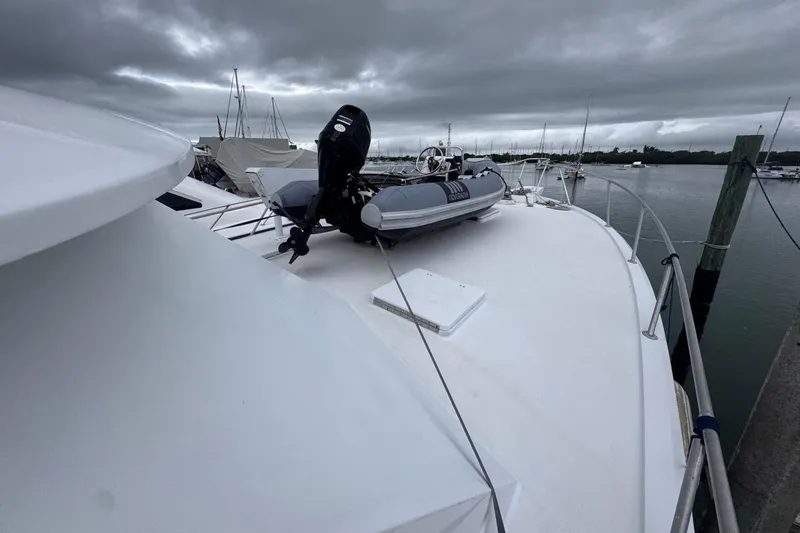 Slide: The Image of 1979 Hatteras 53 Motor Yacht deck with inflatable boat under cloudy skies. - 72
