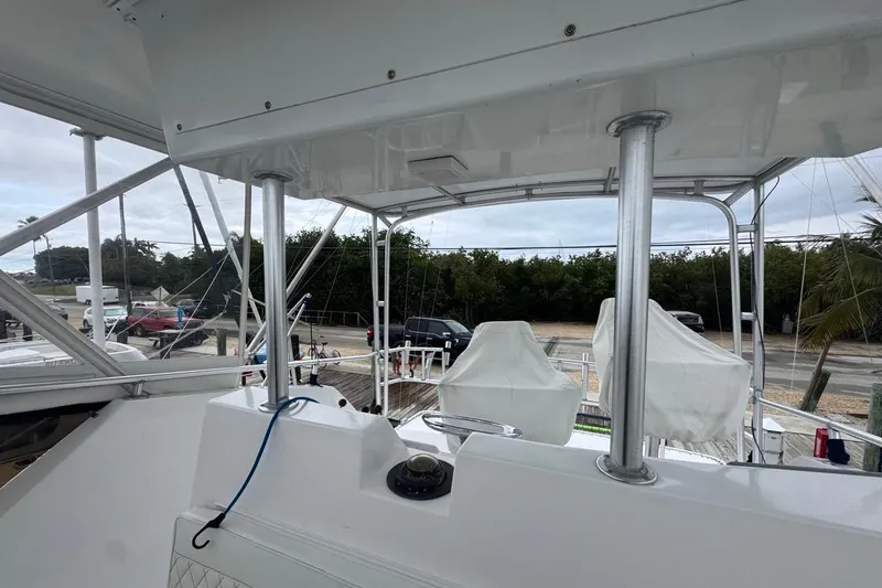 Slide: The Image of 1979 Hatteras 53 Motor Yacht deck with covered seating and railing. - 74