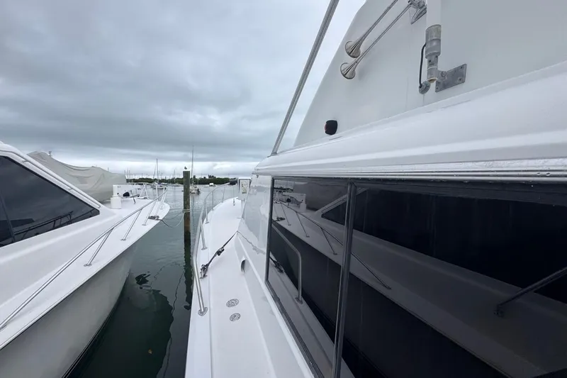 Slide: The Image of 1979 Hatteras 53 Motor Yacht docked, showcasing sleek design and spacious deck. - 78
