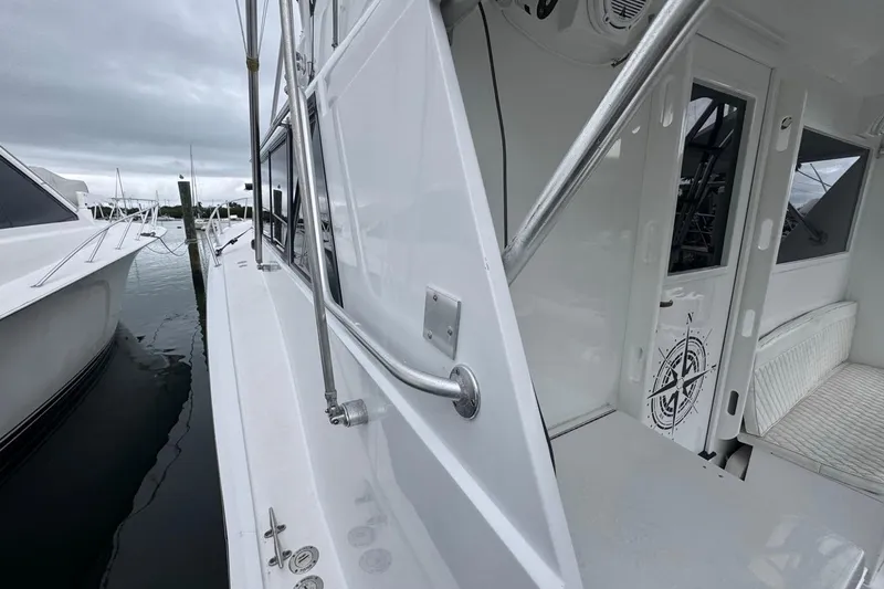 Slide: The Image of 1979 Hatteras 53 Motor Yacht docked, showcasing sleek white exterior and nautical design elements. - 80