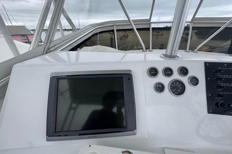 Slide: The Image of 1979 Hatteras 53 Motor Yacht helm with Garmin display and gauges. - 82