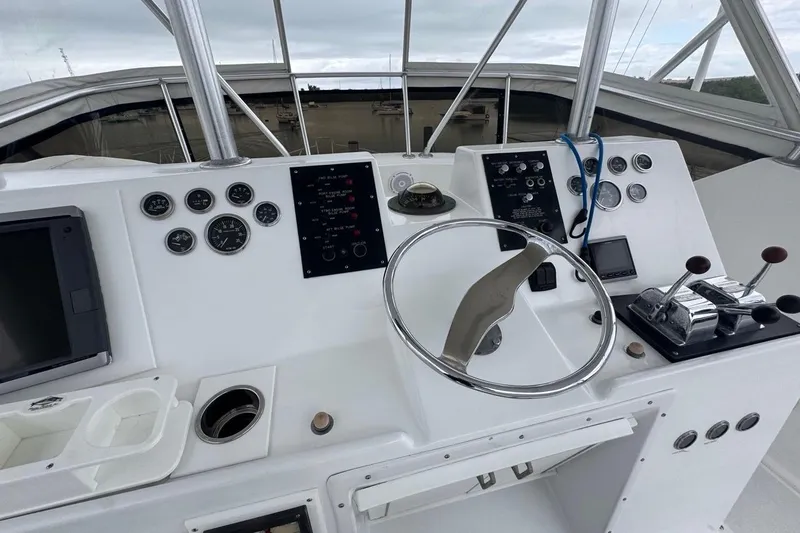 Slide: The Image of Helm of 1979 Hatteras 53 Motor Yacht with steering wheel and control panels. - 83