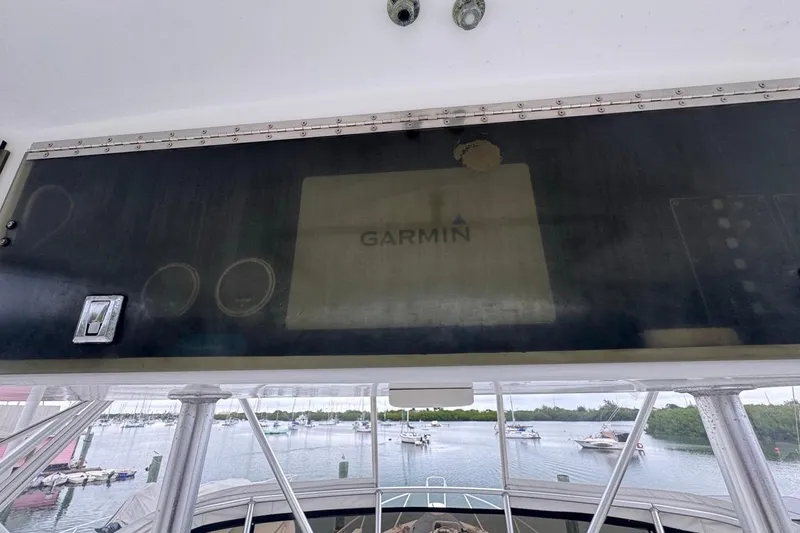 Slide: The Image of 1979 Hatteras 53 Motor Yacht helm with Garmin navigation system, overlooking marina. - 86