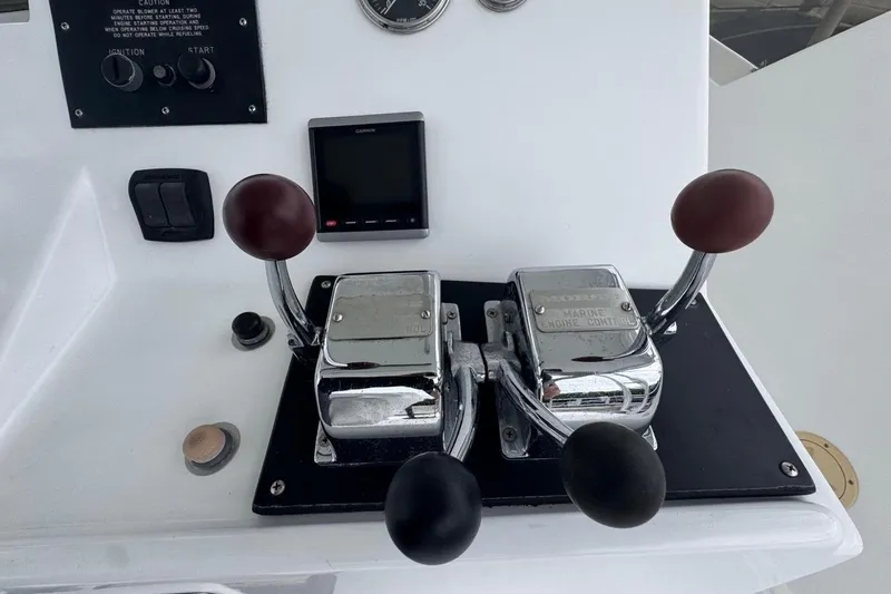 Slide: The Image of Control panel of a 1979 Hatteras 53 Motor Yacht with throttle levers and gauges. - 89