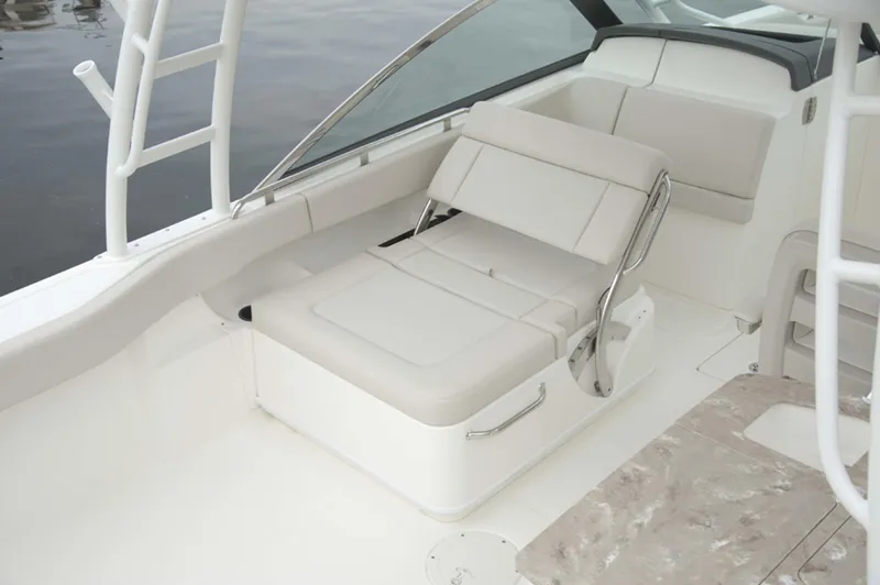 Slide: The Image of Manufacturer Provided Image: 2014 Boston Whaler 270 Vantage boat interior with white seating and stainless steel accents. - 12